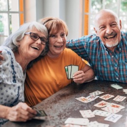 friends smiling while playing card games