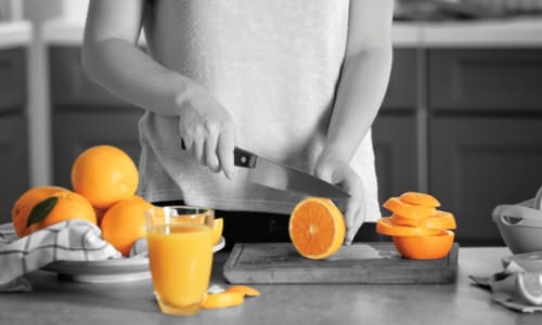 woman cutting oranges in her kitchen