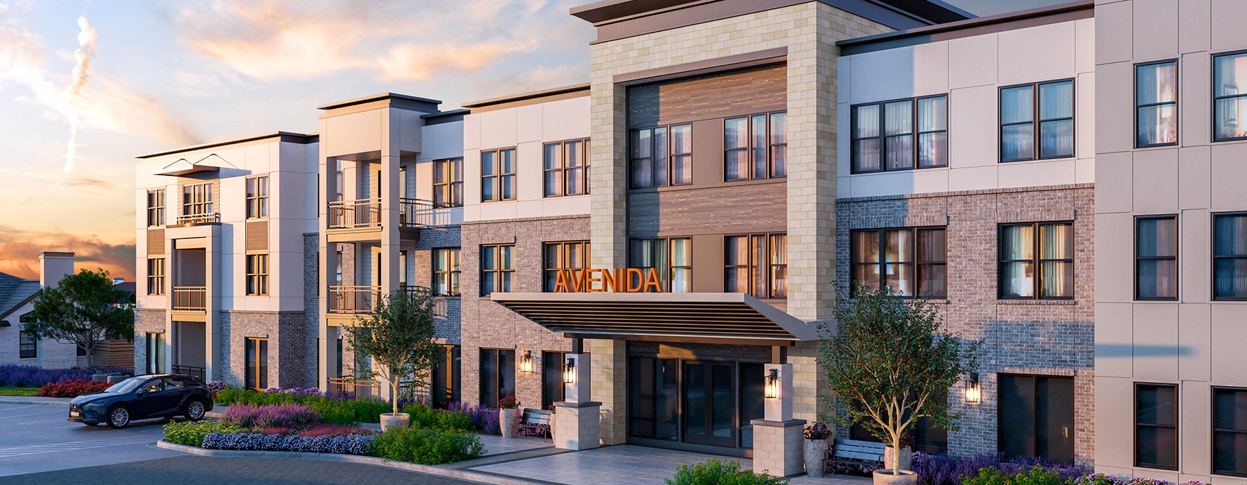The entrance to our 55 and over housing in Carrollton, TX, featuring a sign reading "AVENIDA" and a view of the exterior.